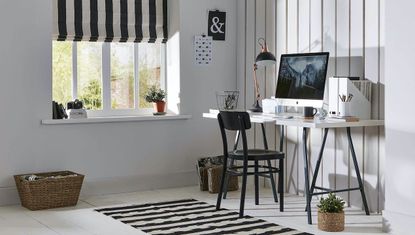 Home office with blue wallpaper and blue patterned flooring.