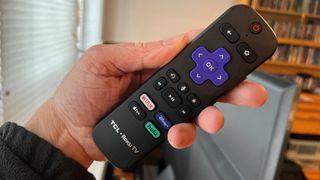 TCL 6-series 2022 TV remote control in a hand