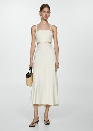 Model wearing white midi dress with cut outs by Mango
