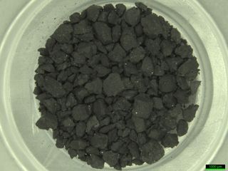 dark rocks in a white container