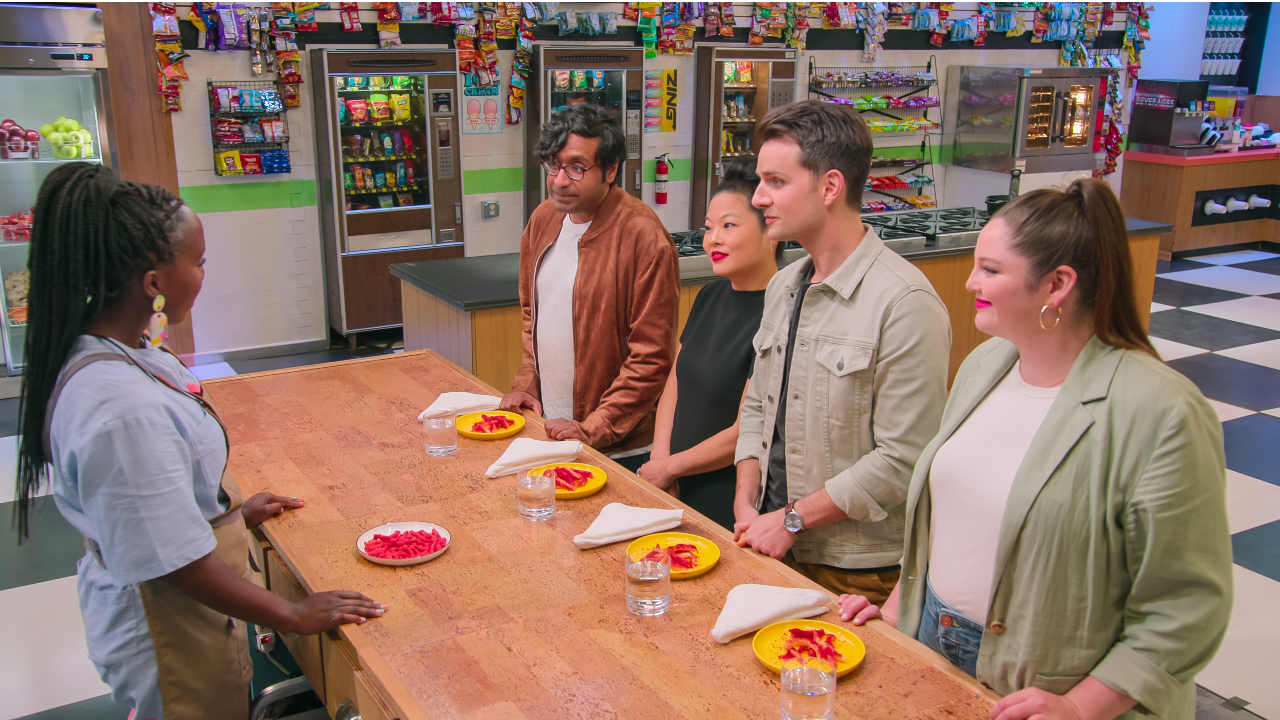 Contestant talks to Snack vs. Chef judges