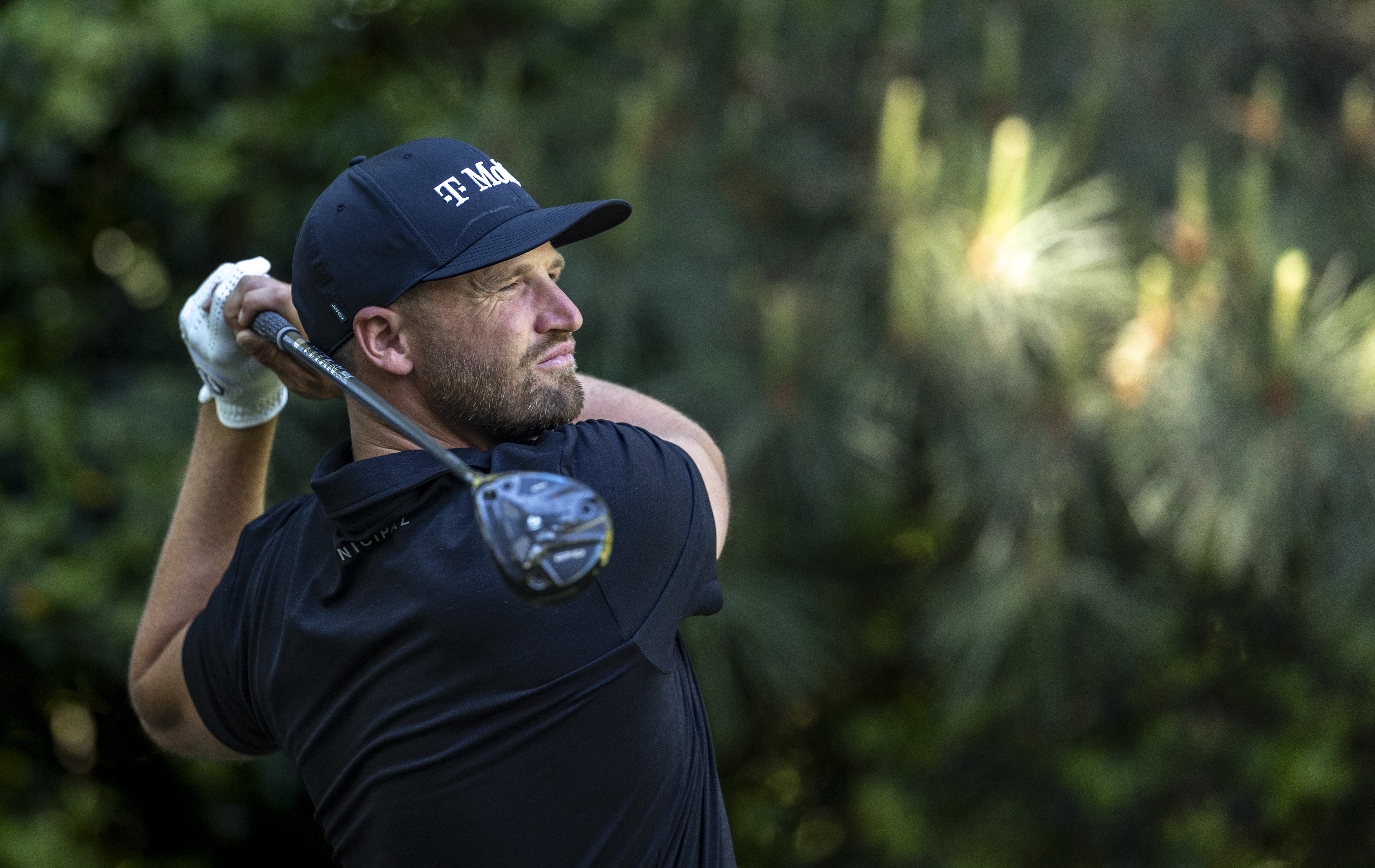 Wyndham Clark plays his shot from the No. 7 tee during a practice round prior to the Masters at Augusta National Golf Club