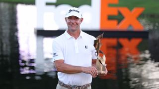 Lucas Glover of the United States poses with the trophy after putting in to win during the first playoff hole on the 18th green to win the tournament during the final round of the FedEx St. Jude Championship at TPC Southwind on August 13, 2023 in Memphis, Tennessee.