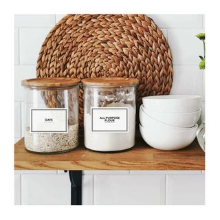 clear glass jars on wooden shelf with labels