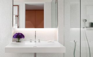 One of the simple, white-tiled bathrooms