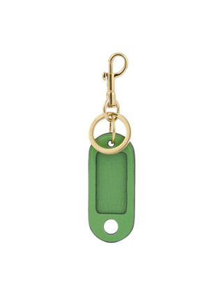 A leather and gold luggage tag in green.