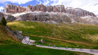 PASSO FEDAIA, ITALY - MAY 28: A general view of the Peloton passing through Arabba (1601m) Italian Dolomites mountainous landscape during the 105th Giro d'Italia 2022, Stage 20 a 168km stage from Belluno to Marmolada - Passo Fedaia 2052m / #Giro / #WorldTour / on May 28, 2022 in Passo Fedaia, Italy. (Photo by Tim de Waele/Getty Images)