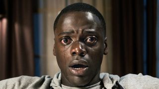 Get Out lead character looking shocked with tears rolling down his face