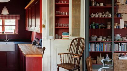 dark red kitchen, neutral cabinet with red inside, dark red shelving unit in dining room