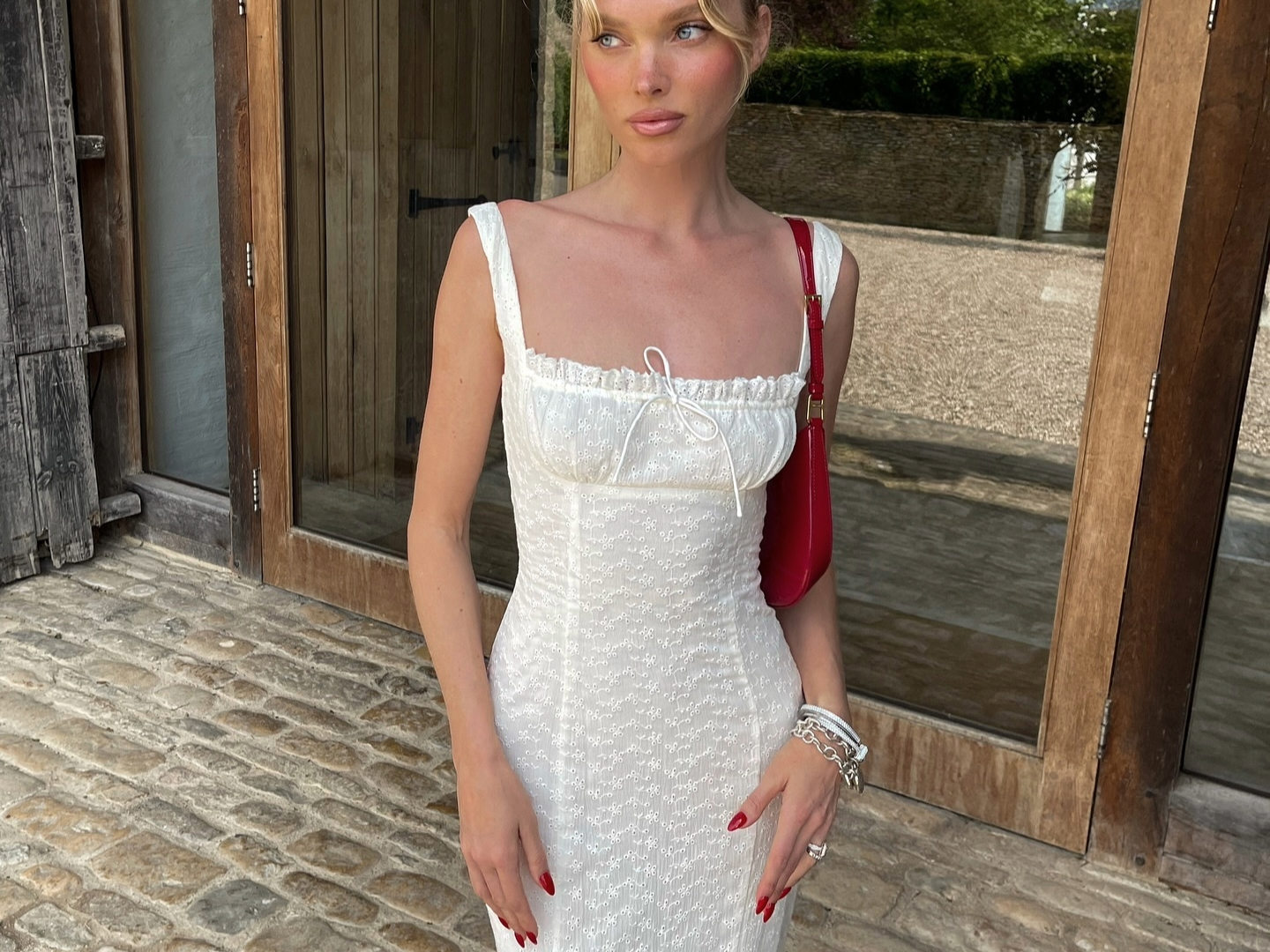 Elsa Hosk in a white eyelet Helsa dress.