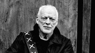 David Gilmour in front of a wooden fence