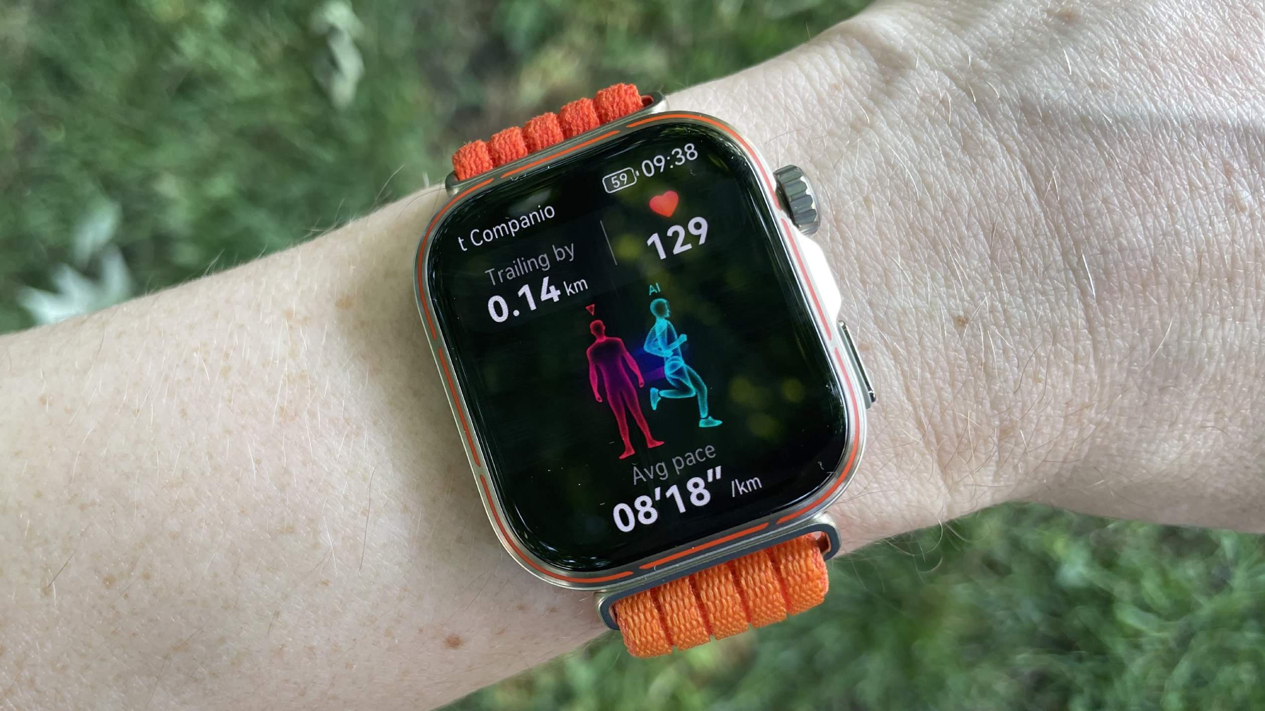 Huawei Watch Fit 5 Pro worn on a run, in front of a grassy background