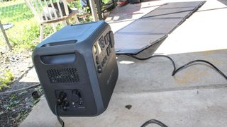 The Bluetti AC200L portable power station with a solar panel connected to it