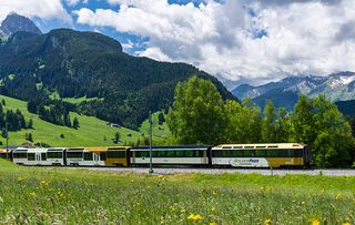 Panoramic train of the MOB Montreux-Oberland Bernois railway on the GoldenPass line close to Gstaad, Switzerland