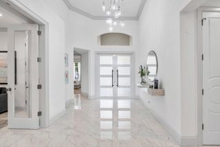 Light entryway with marble floor and double doors
