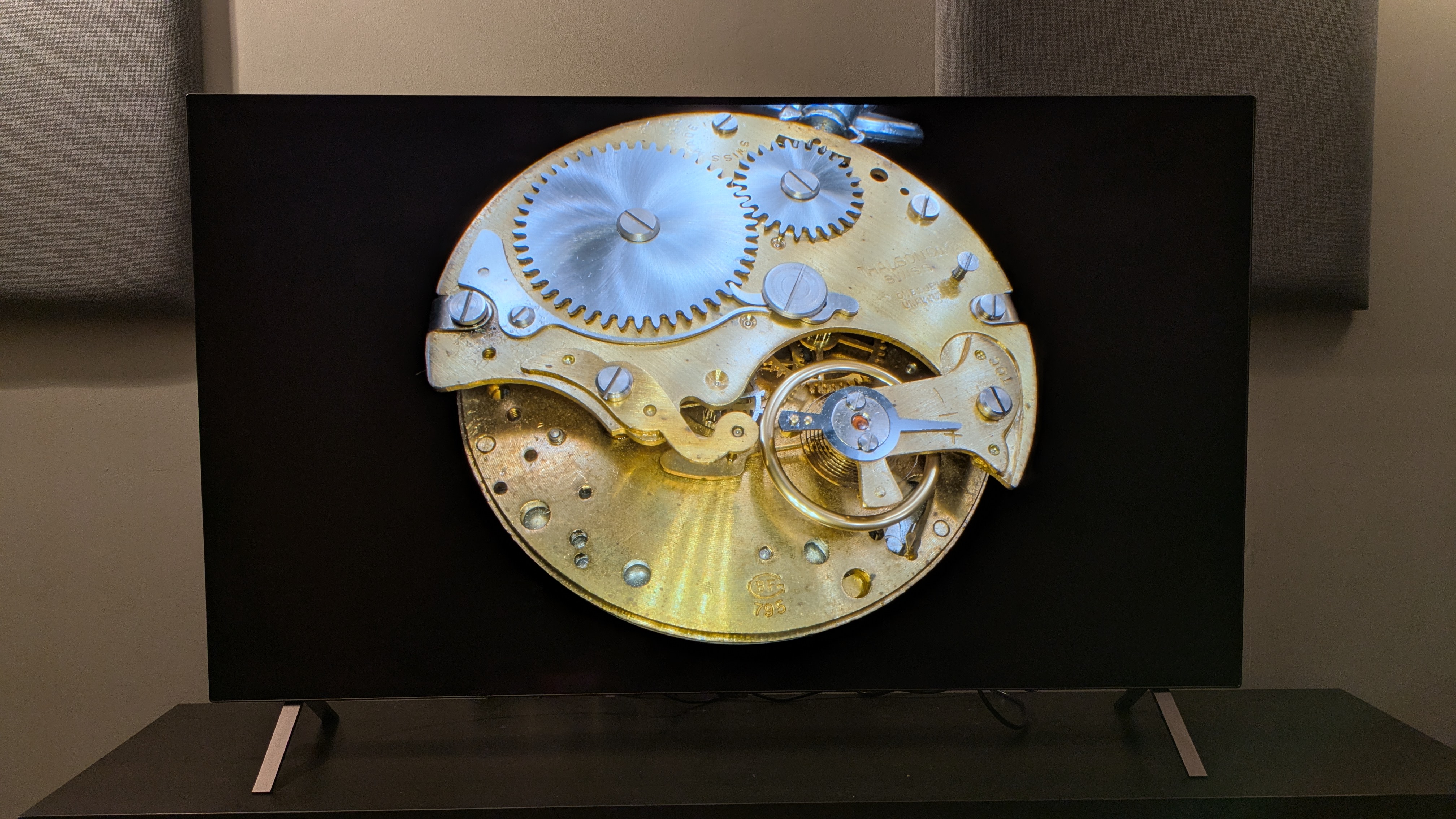 LG B5 OLED TV with gold stopwatch inner mechanisms on screen