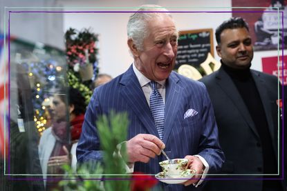 King Charles laughing holding a cup of tea