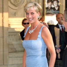 Princess Diana wearing a blue dress and smiling