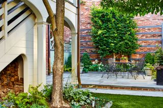 backyard garden patio with bistro set and garden border by Joseph Richardson of Richardson & Associates Landscape Architecture