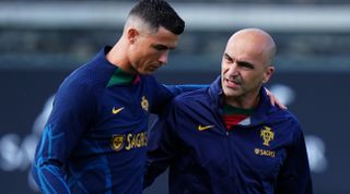 Portugal manager Roberto Martinez of Portugal speaks with Cristiano Ronaldo of Portugal during a training session at Cidade do Futebol FPF on June 13, 2023 in Oeiras, Portugal.