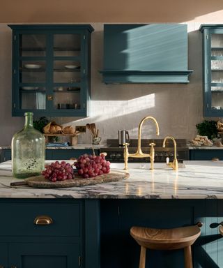 blue devol kitchens with upper glass fronted cabinets