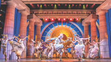 Cast of Hercules dancing on stage