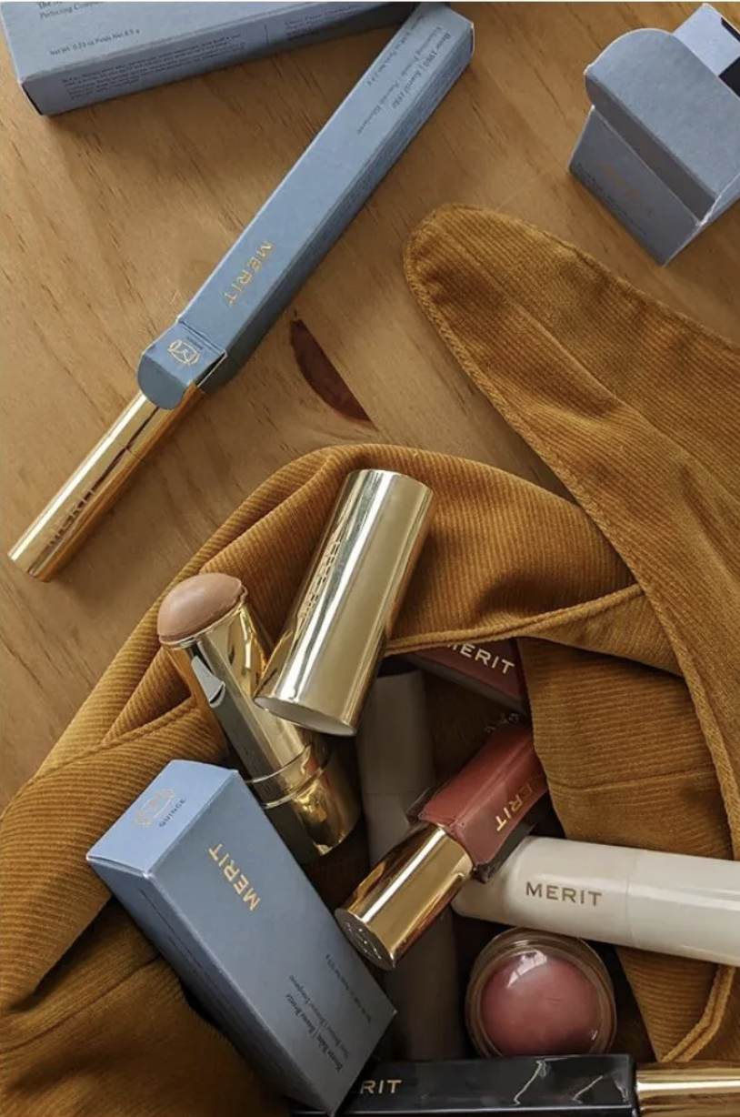 A close-up of Merit's makeup bag and products inside
