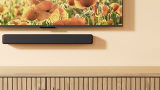 The Amazon Fire TV Soundbar mounted on a beige wall.