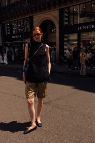 woman wearing cargo bermuda shorts and black top