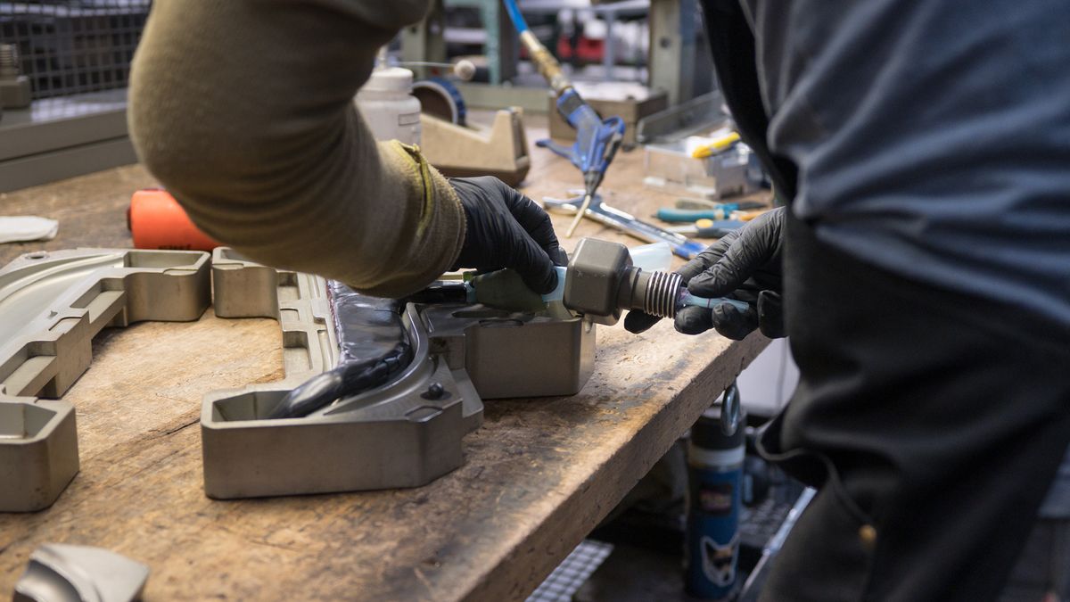 carbon fiber bike handlebar being placed into a mould
