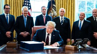 president trump signs coronavirus stimulus bill in the oval office