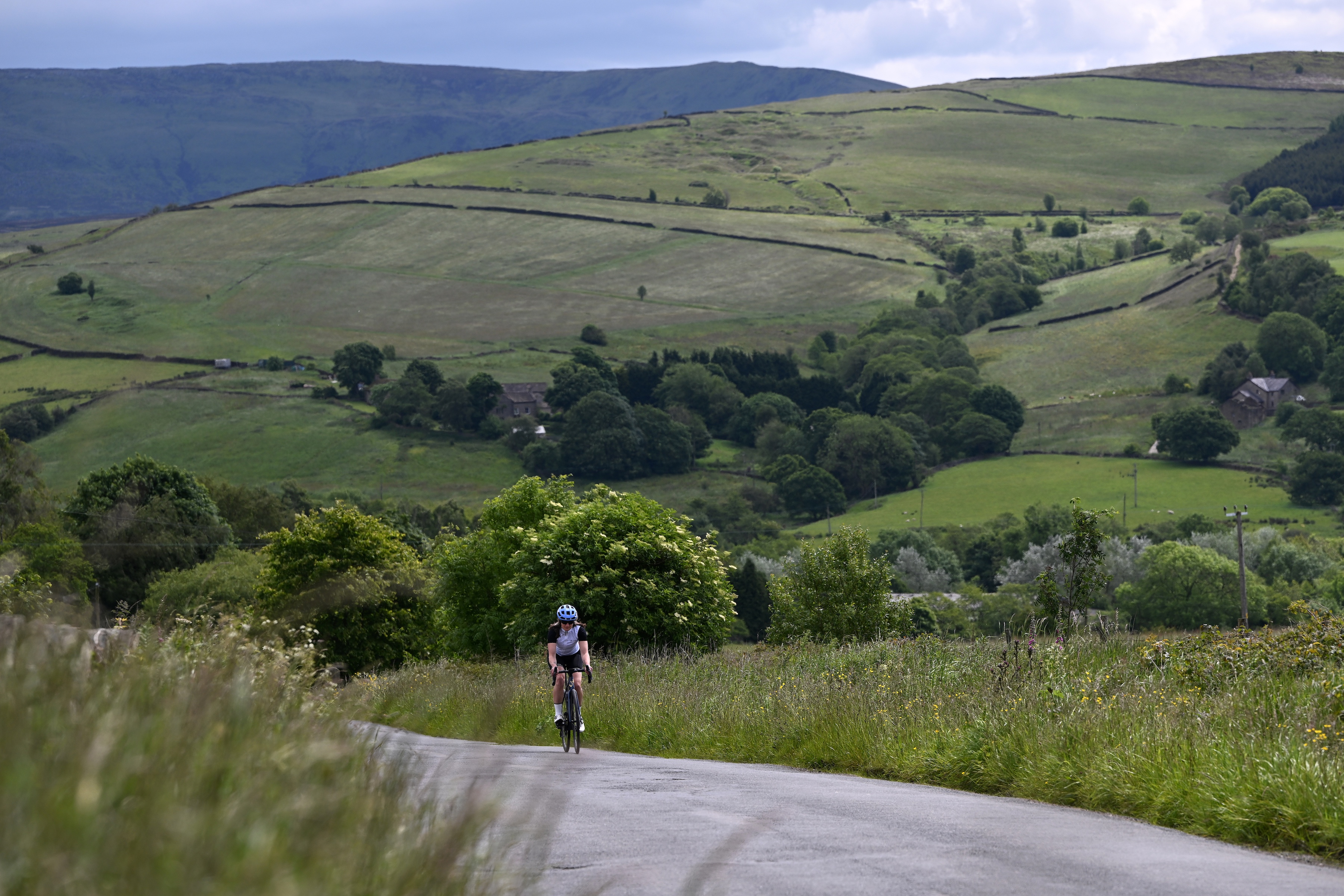 a female cyclist riding in the Yorkshire hills