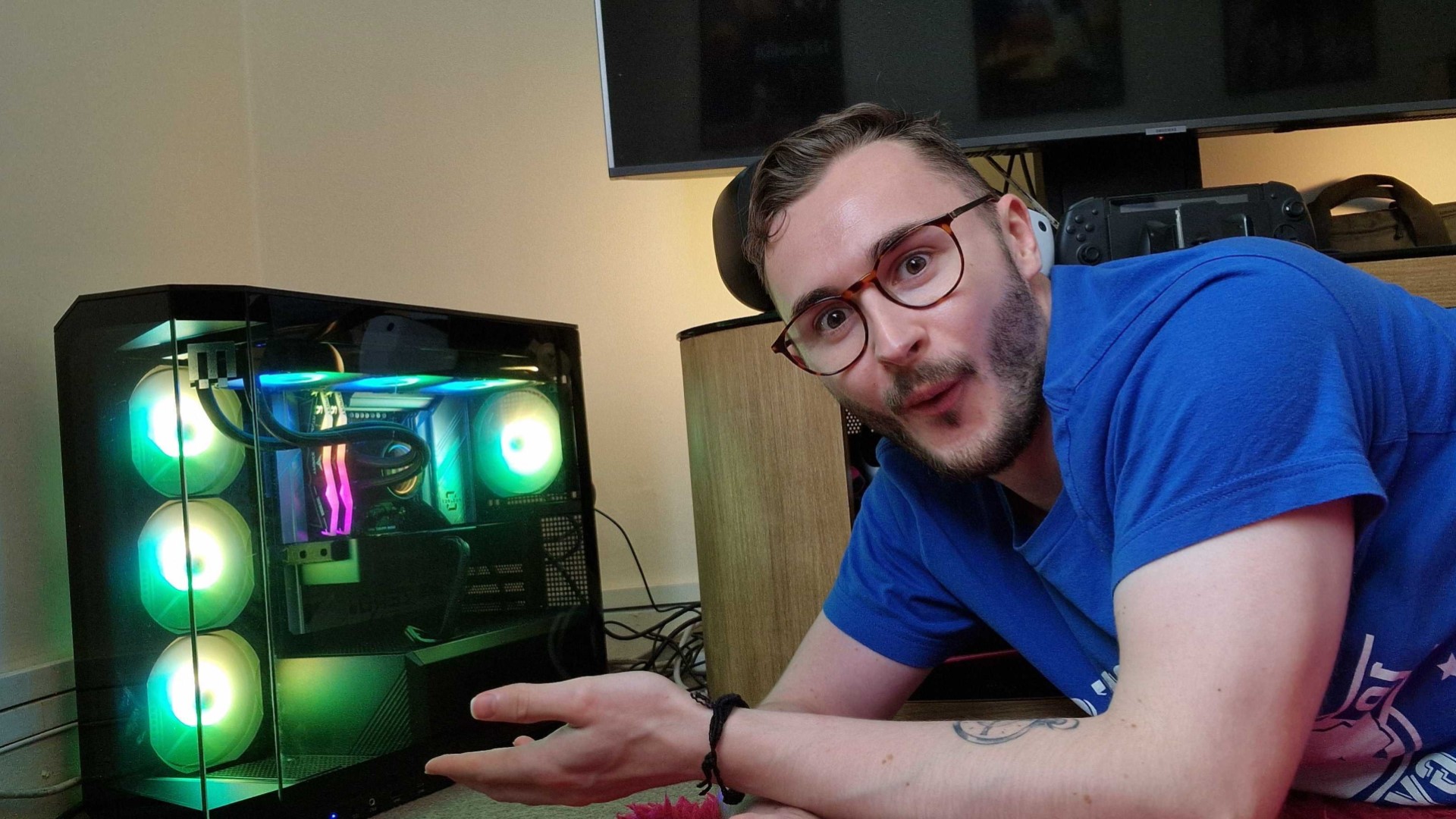 GamesRadar Hardware Editor Duncan Robertson posing with an RGB lit gaming PC