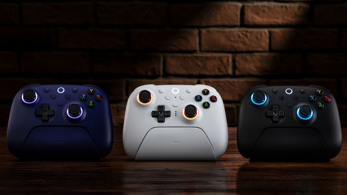 8BitDo Ultimate 2 controllers lined up in a row, showing off Black, White and Purple colorways.