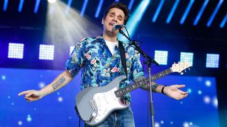 John Mayer performs live with a PRS Silver Sky electric guitar