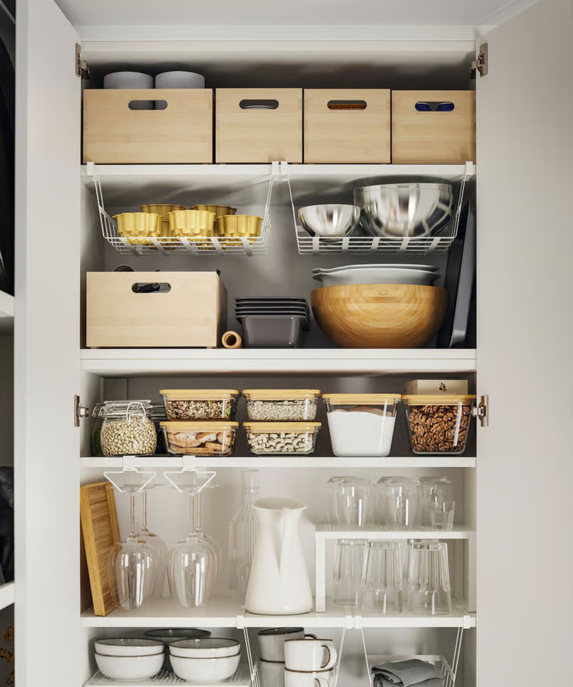 A white pantry with light bamboo storage boxes on the shelves, glass food containers with bamboo lids below.