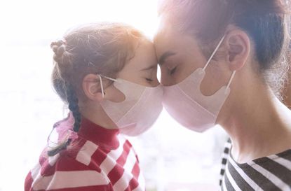 mother and little daughter wearing surgial mask