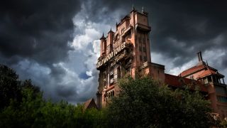 The Twilight Zone Tower Of Terror ride building shown against a stormy sky.