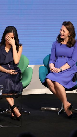 Kate Middleton sat with Meghan Markle, who hides her face in her hands