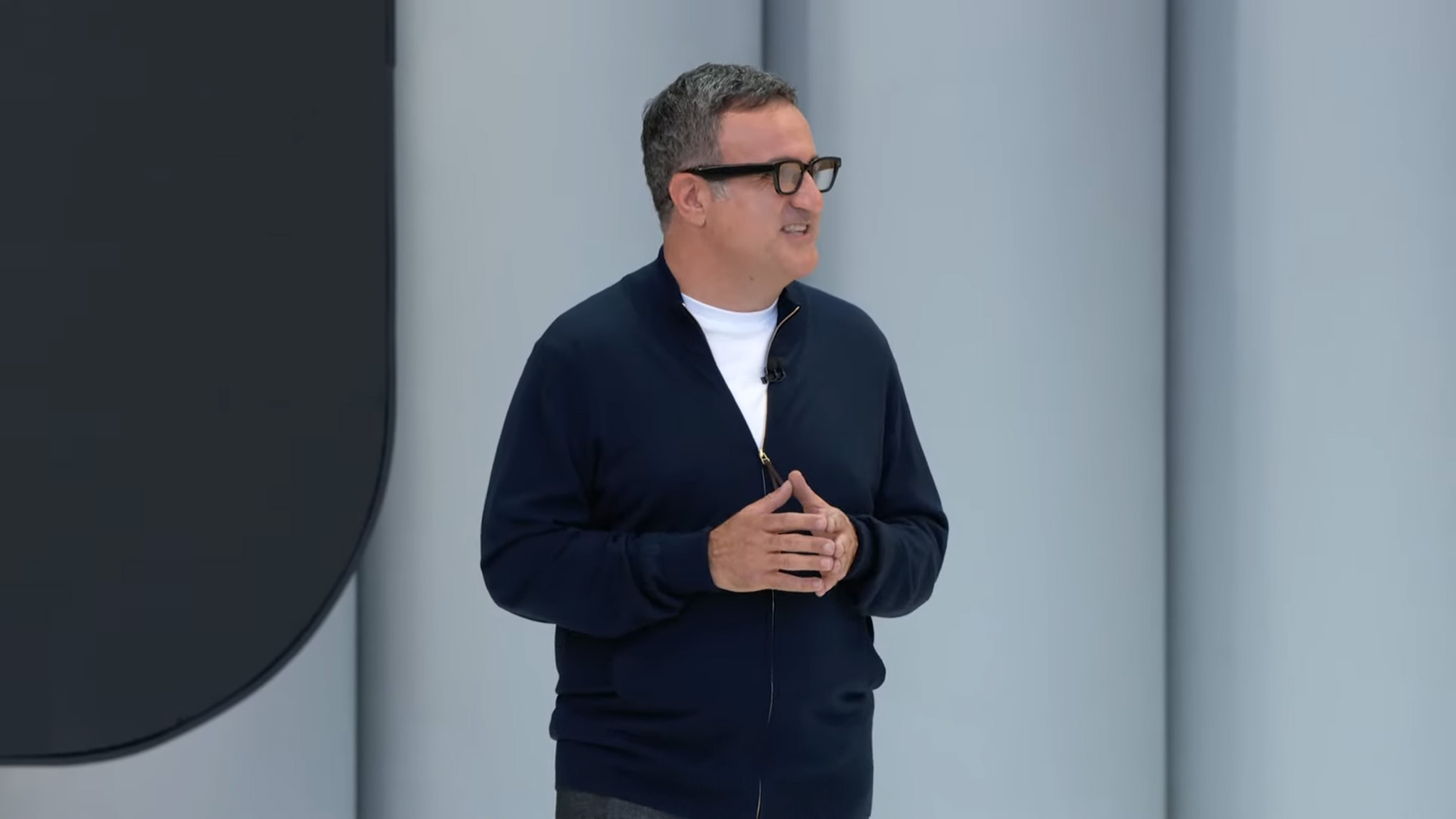 Shahram Izadi on stage at Google I/O 2025 wearing what's likely a pair of Google XR glasses