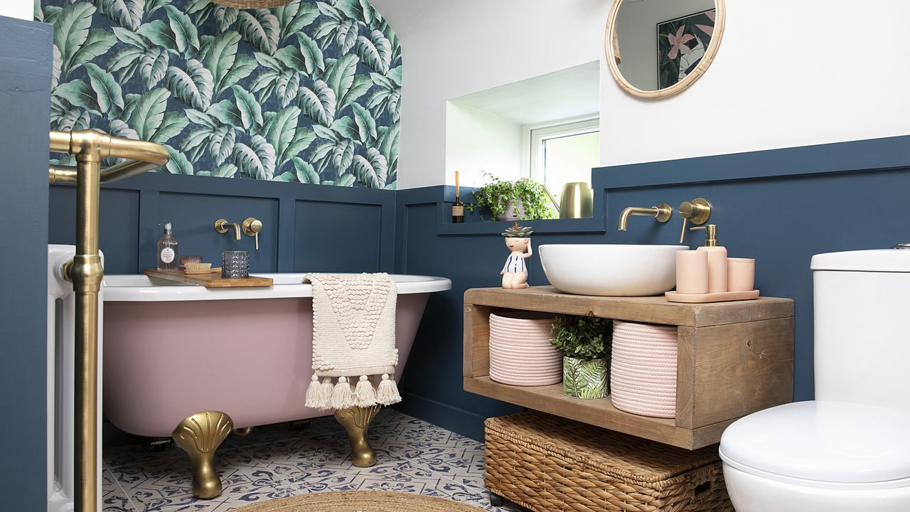 Blue panelled bathroom with palm wallpaper, patterned tile flooring, jute rug and rustic wall-hung floating vanity unit