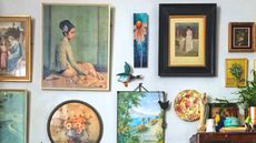 Vintage prints on a wall in a living room by Lisa Piddington