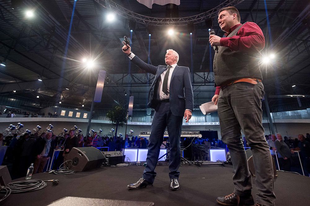 Patrick Lefevere shoots the starter's pistol at the Etixx-QuickStep team presentation.
