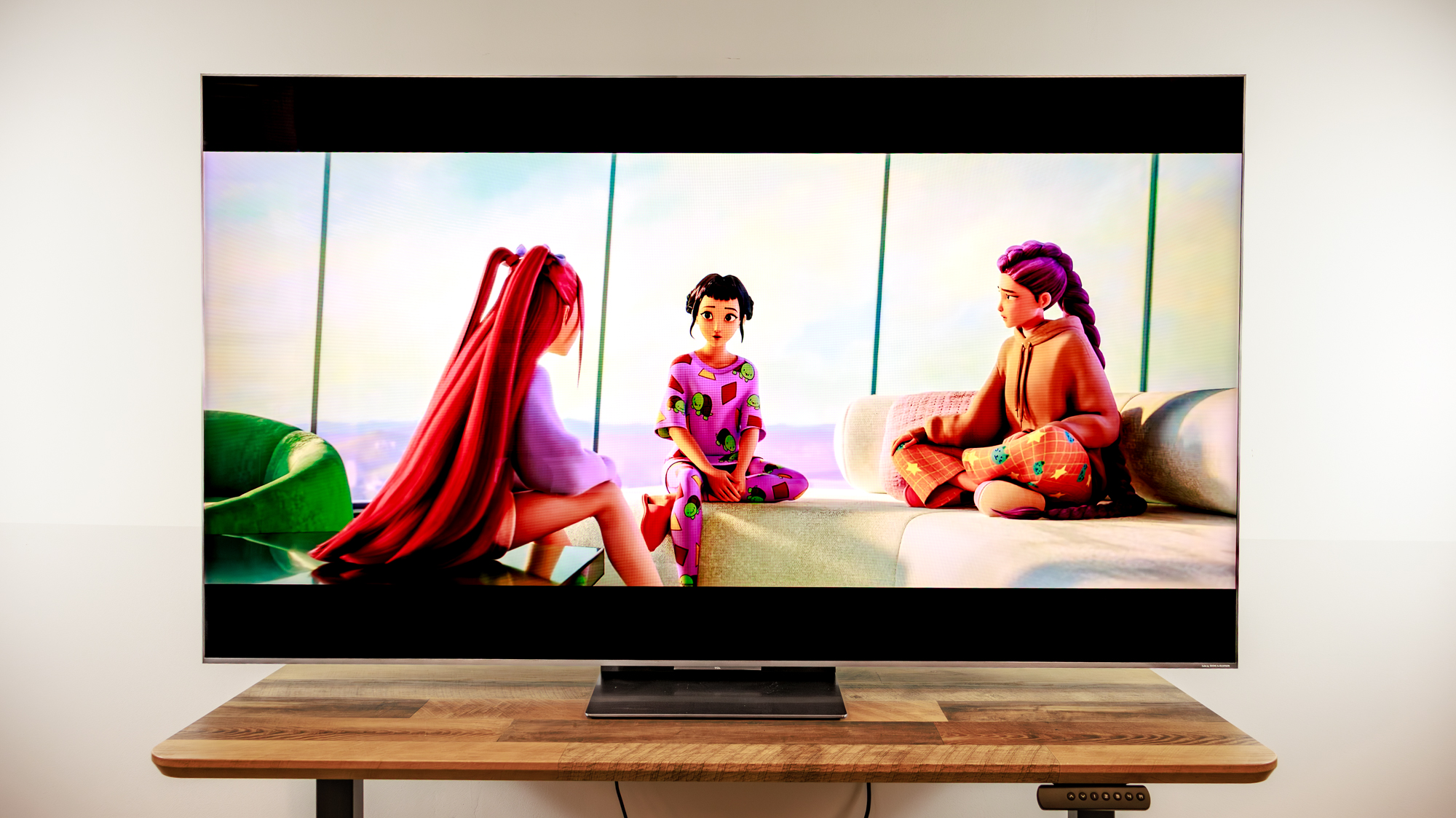 A TCL QM8L TV on a desk