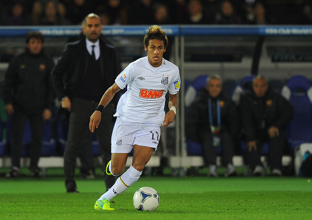 A young Neymar in action for Santos against Barcelona in 2011, with then-Barcelona boss Pep Guardiola watching from the dugout