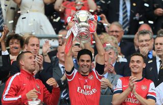 Arsenal captain Mikel Arteta (centre) lifts the FA Cup