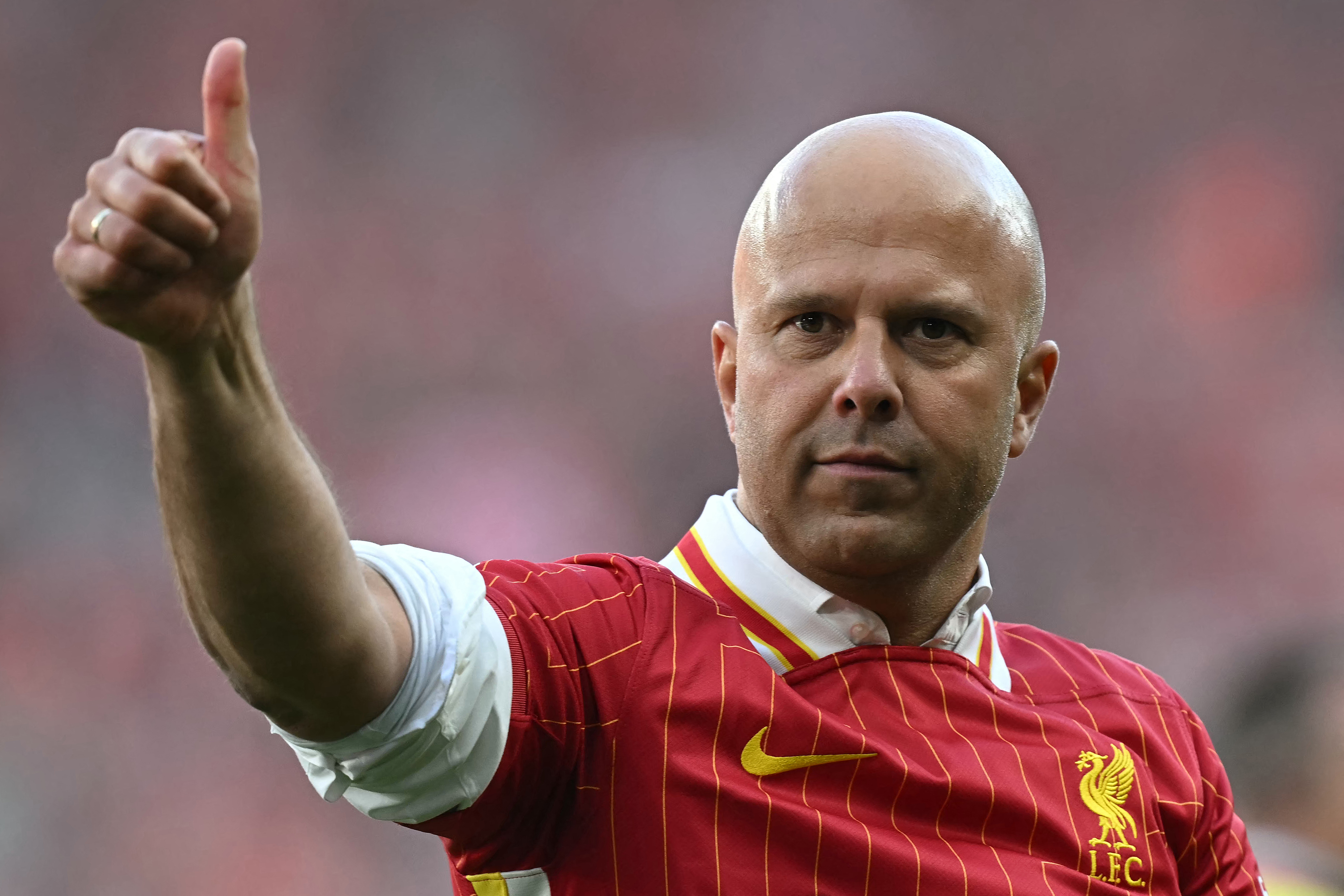 Arne Slot gives the thumbs up to Liverpool fans after a 5-1 win over Tottenham at Anfield secured the Premier League title in April 2025.