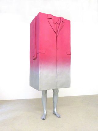 White legs protrude from the bottom of a large block-shaped coat, which is pink at the top fading to white at the bottom