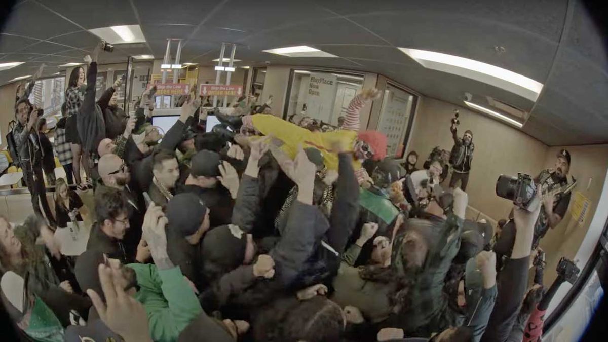 Knuckleheadz performing art McDonalds, with someone dressed as Ronald McDonald crowd surfing