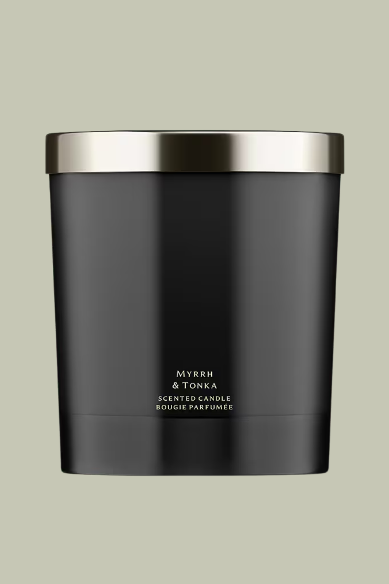 A black candle with a silver lid